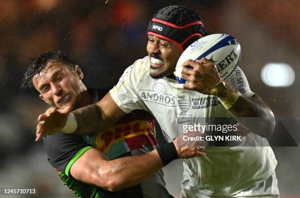 Harlequins' English wing Josh Bassett tackles Racing92's New Zealander centre Francis Saili during the European Rugby Champions Cup pool A rugby...