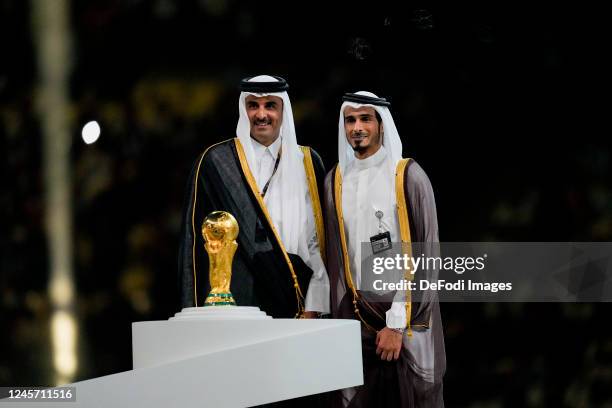 Hamad bin Khalifa Al Thani Emir of Qatar looks on with the world cup trophy after the FIFA World Cup Qatar 2022 Final match between Argentina and...