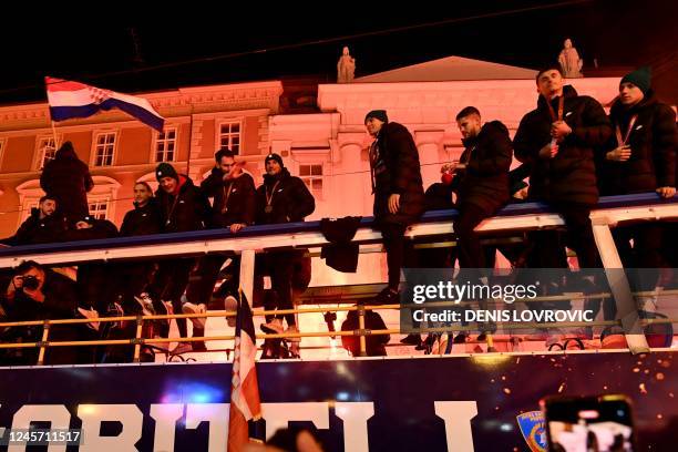 Croatian national football team's players celebrate on a bus during a welcoming ceremony upon their return from the Qatar 2022 World Cup, in central...