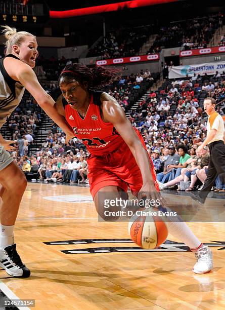 Nicky Anosike of the Washington Mystics drives against Jayne Appel of the San Antonio Silver Stars at the AT&T Center on September 10, 2011 in San...