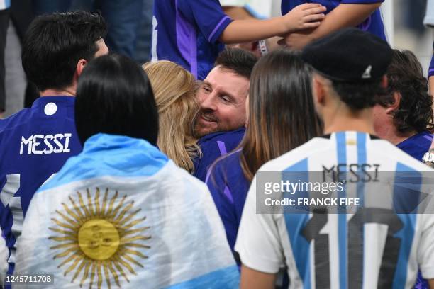 Argentina's forward Lionel Messi is embraced by his mother Celia Maria Cuccittini as he celebrates after the awards ceremony after winning the Qatar...