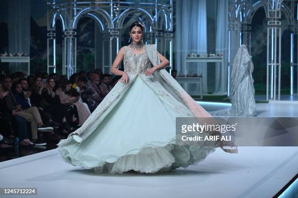 Model presents a creation by fashion designer Sheeba Kapadia at the 20th edition of the Pantene HUM Bridal Couture Week in Lahore on December 18,...
