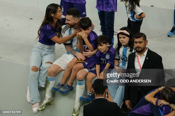 Argentina's captain and forward Lionel Messi celebrates with his family after Argentina won the Qatar 2022 World Cup final football match between...