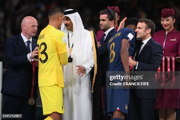 France's goalkeeper Alphonse Areola and France's midfielder Aurelien Tchouameni are greeted by Qatar's Emir Sheikh Tamim bin Hamad al-Thani , FIFA...
