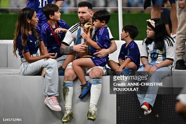 Argentina's captain and forward Lionel Messi celebrates with his family after Argentina won the Qatar 2022 World Cup final football match between...