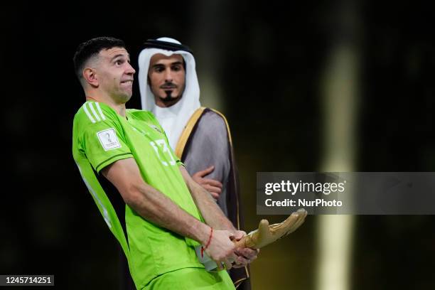 Emiliano Martinez goalkeeper of Argentina and Aston Villa whit his trophy of Best Goalkeeper after the FIFA World Cup Qatar 2022 Final match between...