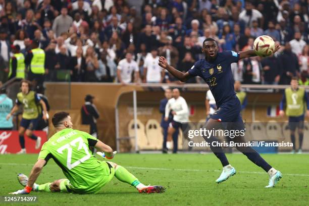 Randal Kolo Muani of France competes with Emiliano Martinez of Argentina during the FIFA World Cup Qatar 2022 Final match between Argentina and...