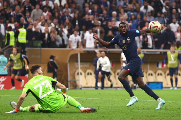 Randal Kolo Muani of France competes with Emiliano Martinez of Argentina during the FIFA World Cup Qatar 2022 Final match between Argentina and...