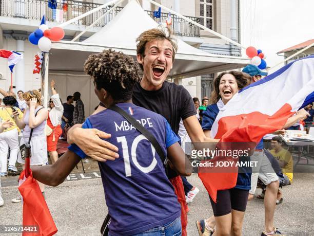 Fans celebrate after France's second goal as they watch the final football match of the Qatar 2022 World Cup between Argentina and France on a screen...