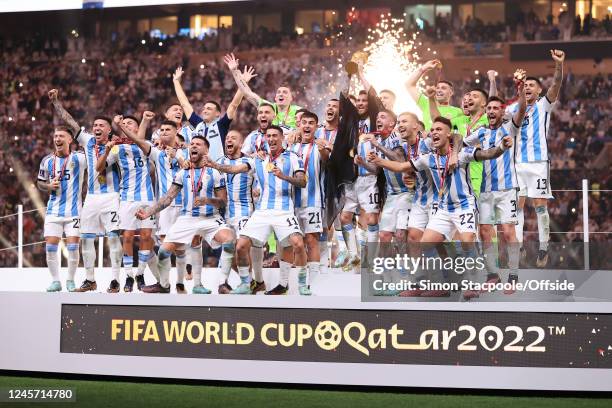 Lionel Messi of Argentina holds the trophy aloft after the FIFA World Cup Qatar 2022 Final match between Argentina and France at Lusail Stadium on...