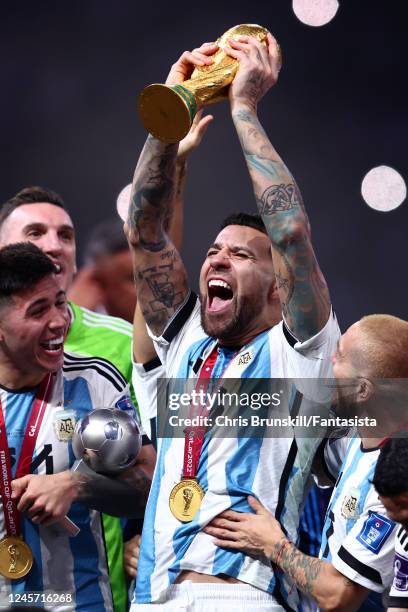 Nicolas Otamendi of Argentina lifts the World Cup trophy with his team-mates at the end of the FIFA World Cup Qatar 2022 Final match between...