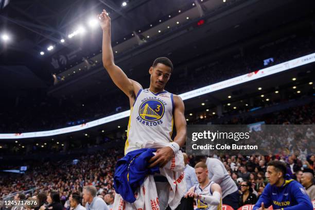 Jordan Poole of the Golden State Warriors reacts on the bench during the first half of their NBA game against the Toronto Raptors at Scotiabank Arena...