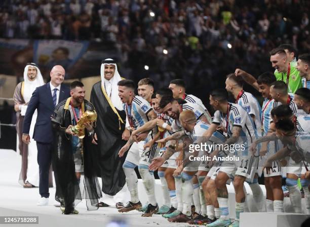 Lionel Messi of Argentina, Sheikh Tamim bin Hamad Al Thani, Emir of Qatar and Gianni Infantino, President of FIFA are seen in the trophy presentation...