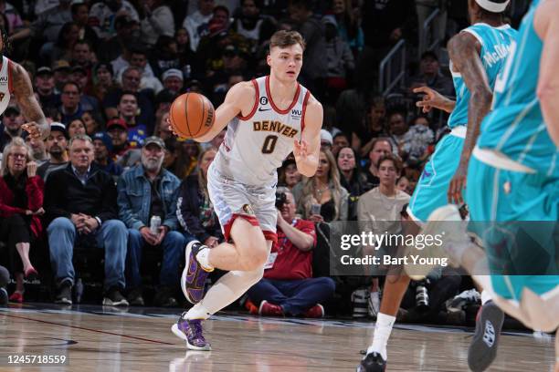 Christian Braun of the Denver Nuggets dribbles the ball during the game against the Charlotte Hornets on December 18, 2022 at the Ball Arena in...