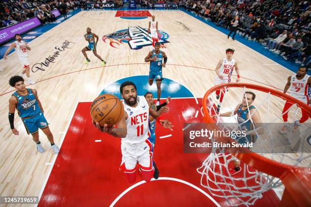 Kyrie Irving of the Brooklyn Nets drives to the basket during the game against the Detroit Pistons on December 18, 2022 at Little Caesars Arena in...