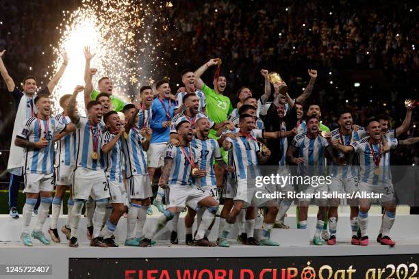 Lionel Messi of Argentina and team lift trophy after winning the FIFA World Cup Qatar 2022 Final match between Argentina and France at Lusail Stadium...