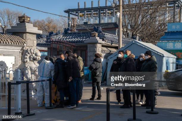 People wait outside Dongjiao Funeral Parlor, reportedly designated to handle Covid fatalities, in Beijing, China, on Monday, Dec. 19, 2022. More than...