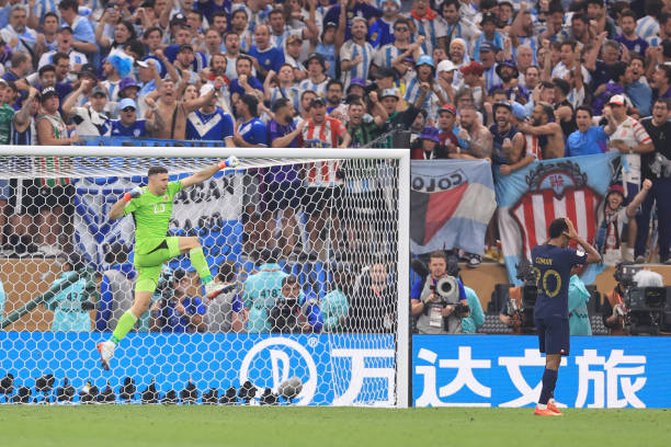 Argentina goalkeeper Emiliano Martinez celebrates saving the penalty from Kingsley Coman of France in the shoot-out during the FIFA World Cup Qatar...