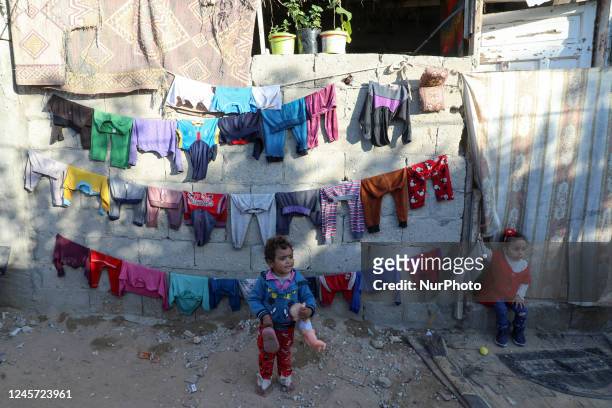 Palestinian children play outside their homes in a poor neighborhood in Beit Lahia in the northern Gaza Strip on December 19, 2022.
