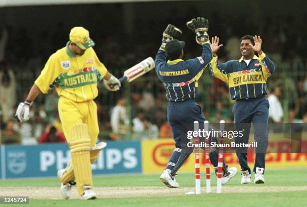 Aravinda De Silva of Sri Lanka celebrates with Kaluwitharana after bowling Ricky Ponting during the Cricket World Cup Final between Australia and Sri...