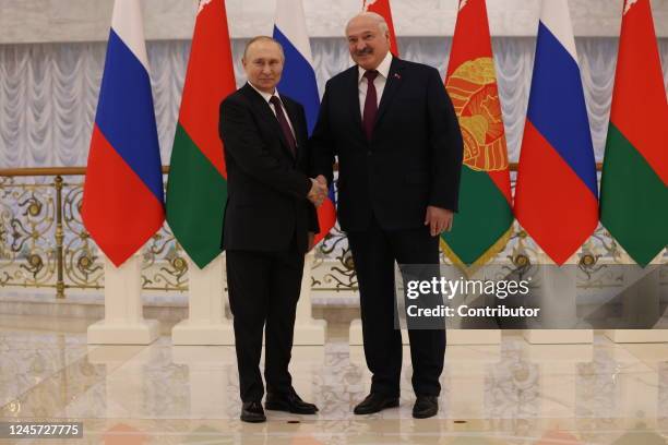 Russian President Vladimir Putin shakes hands with Belarussian President Alexander Lukashenko during the welcoming ceremony at the Palace of...