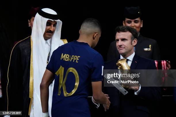 Kylian Mbappe centre-forward of France and Paris Saint-Germain receives the Golden Boot trophy from Emmanuel Macron President of France after the...