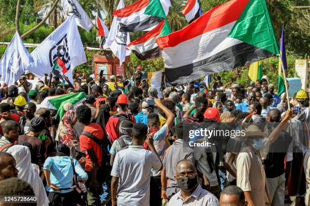 Protesters march with Sudanese national flags in the Bashdar district in the south of Sudan's capital Khartoum on December 19, 2022 during a...