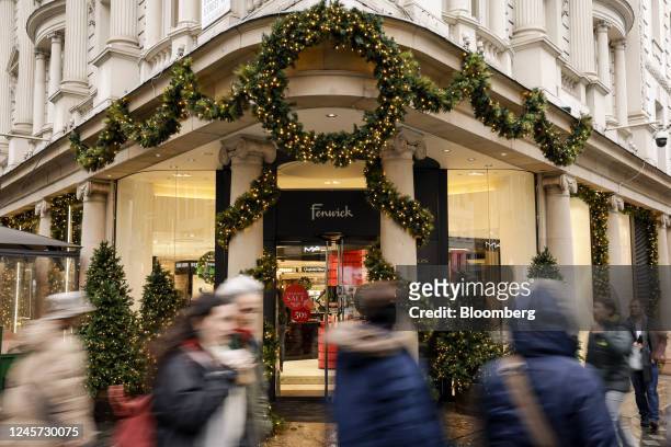 Festive decorations at the entrance to the Fenwick Ltd. Department store on Bond Street in London, UK, on Monday, Dec. 19, 2022. Fenwick is...