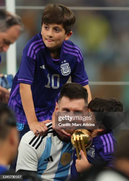 Lionel Messi of Argentina and his sons celebrate with his player of the tournament award after the FIFA World Cup Qatar 2022 Final match between...