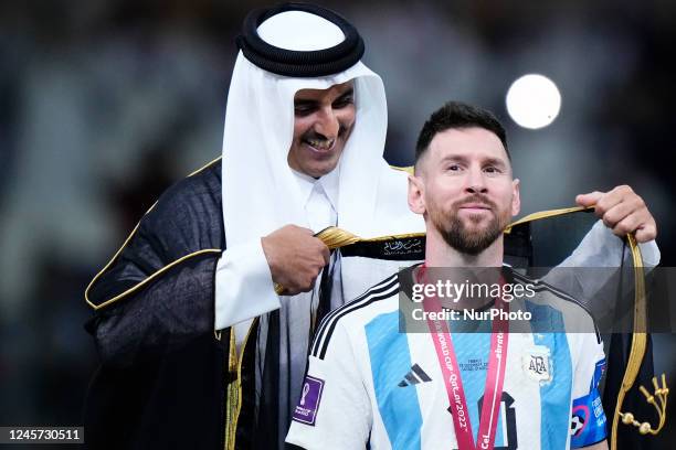 Qatars Emir Tamim Bin Hamad Al Thani puts the besht to Lionel Messi right winger of Argentina and Paris Saint-Germain after the FIFA World Cup Qatar...