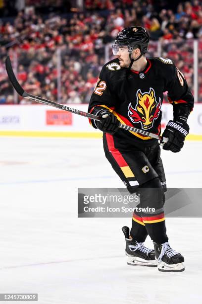 Calgary Flames Defenceman MacKenzie Weegar looks over his should as he retrieves a loose puck during the second period of an NHL game between the...