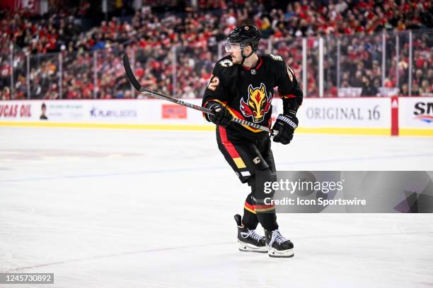 Calgary Flames Defenceman MacKenzie Weegar looks over his should as he retrieves a loose puck during the second period of an NHL game between the...