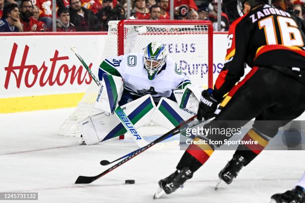 Vancouver Canucks Goalie Spencer Martin keeps his eye on the puck as Calgary Flames Defenceman Nikita Zadorov tries to score during the second period...