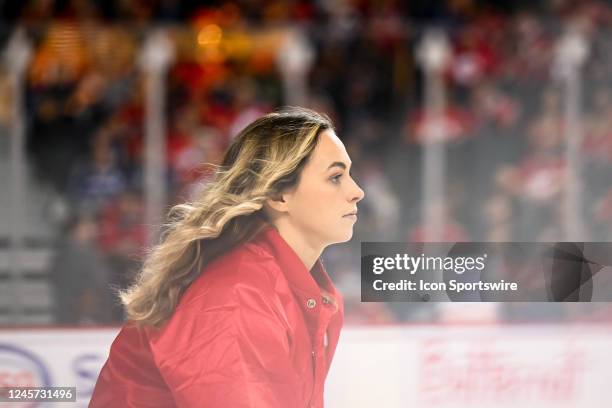 Calgary Flames ice girl shovels the snow during the third period of an NHL game between the Calgary Flames and the Vancouver Canucks on December 14...