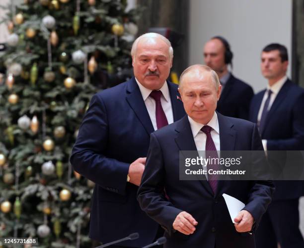 Russian President Vladimir Putin and Belarussian President Alexander Lukashenko enter the hall during their joint press conference at the Palace of...