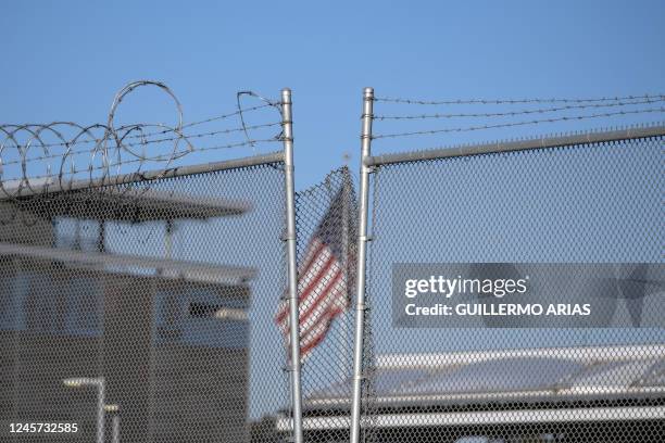 Flag waves at the San Ysidro crossing port in the US-Mexico border seen from Tijuana, Baja California state, Mexico, on December 19, 2022. - Title...