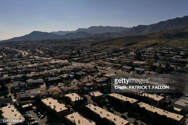 An aerial view shows homes and apartments in a neighborhood in El Paso, Texas, on December 19, 2022. - Housing starts data about new home...