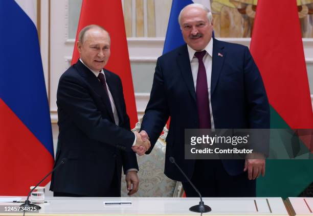 Russian President Vladimir Putin and Belarussian President Alexander Lukashenko shake hands before a press conference at the Palace of Independence...