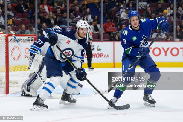 Winnipeg Jets defenceman Dylan Samberg defends against Vancouver Canucks right wing Jack Studnicka during their NHL game at Rogers Arena on December...