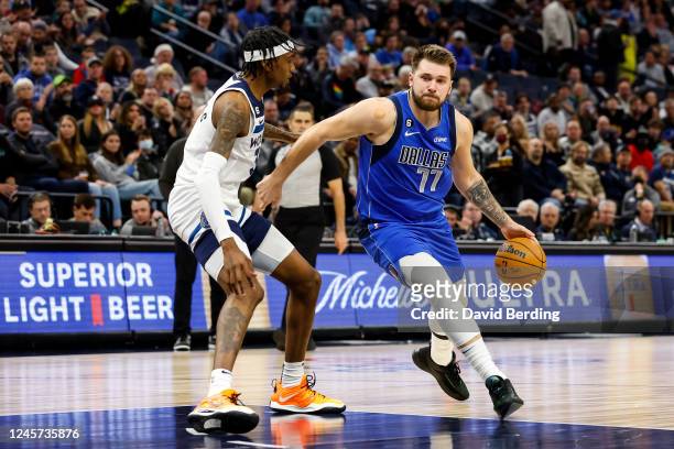 Luka Doncic of the Dallas Mavericks dribbles the ball in the key while Jaden McDaniels of the Minnesota Timberwolves defends in the second quarter of...