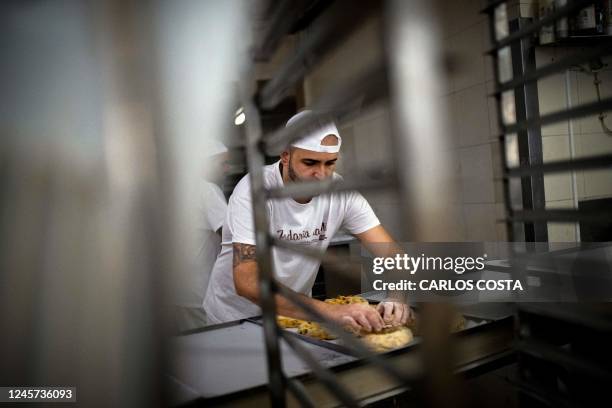 Baker makes "Bolo-Rei" at the Padaria da Ne bakery in Amadora, 12 km from Lisbon, on December 16, 2022. - The "Bolo Rei" ring-shaped cake is one of...