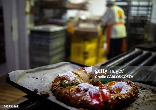 Freshly baked "Bolo-Rei" lies on a try at the Padaria da Ne bakery in Amadora, 12 km from Lisbon, on December 16, 2022. - The "Bolo Rei" ring-shaped...