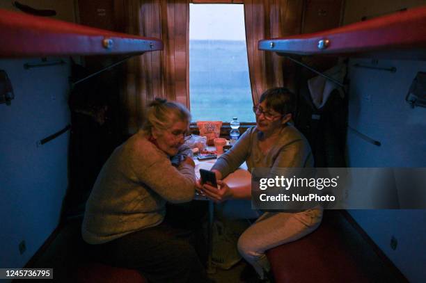 Two women are seen inside an evacuation train from Kherson to Khmelnytskyi, on Sunday, December 18, 2022. Five weeks after liberation, the city of...