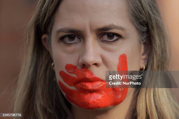 Woman with her face painted red protests outside the Embassy of the Islamic Republic of Iran in Mexico City against the public sentencing to death by...