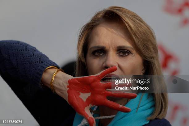 Woman with her hands painted red protests outside the Embassy of the Islamic Republic of Iran in Mexico City against the public sentencing to death...