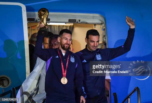 Lionel Messi of Argentina and Lionel Scaloni holds the FIFA World Cup during the arrival of the Argentina men's national football team after winning...
