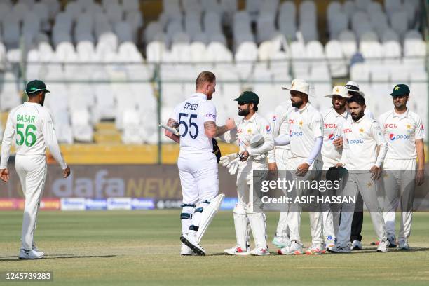 England's captain Ben Stokes greets Pakistan's cricketers after winning the third Test match between Pakistan and England at the National Stadium in...