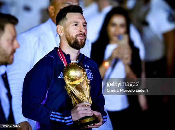 Lionel Messi holds the FIFA World Cup during the arrival of the Argentina men's national football team after winning the FIFA World Cup Qatar 2022 on...