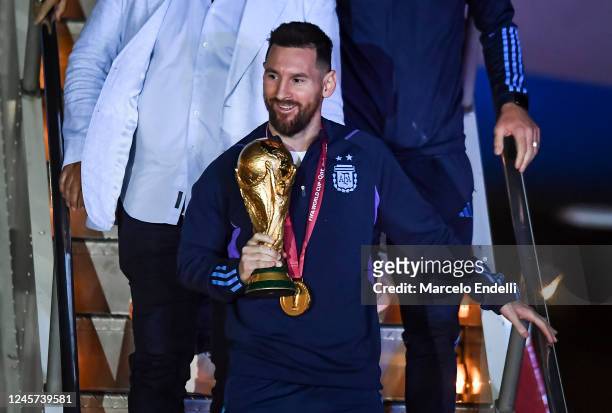 Lionel Messi of Argentina holds the FIFA World Cup during the arrival of the Argentina men's national football team after winning the FIFA World Cup...