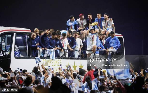 Argentina men's national football team player Lisandro Martinez holds up the FIFA World Cup as they arrive to the teams headquarters after winning...